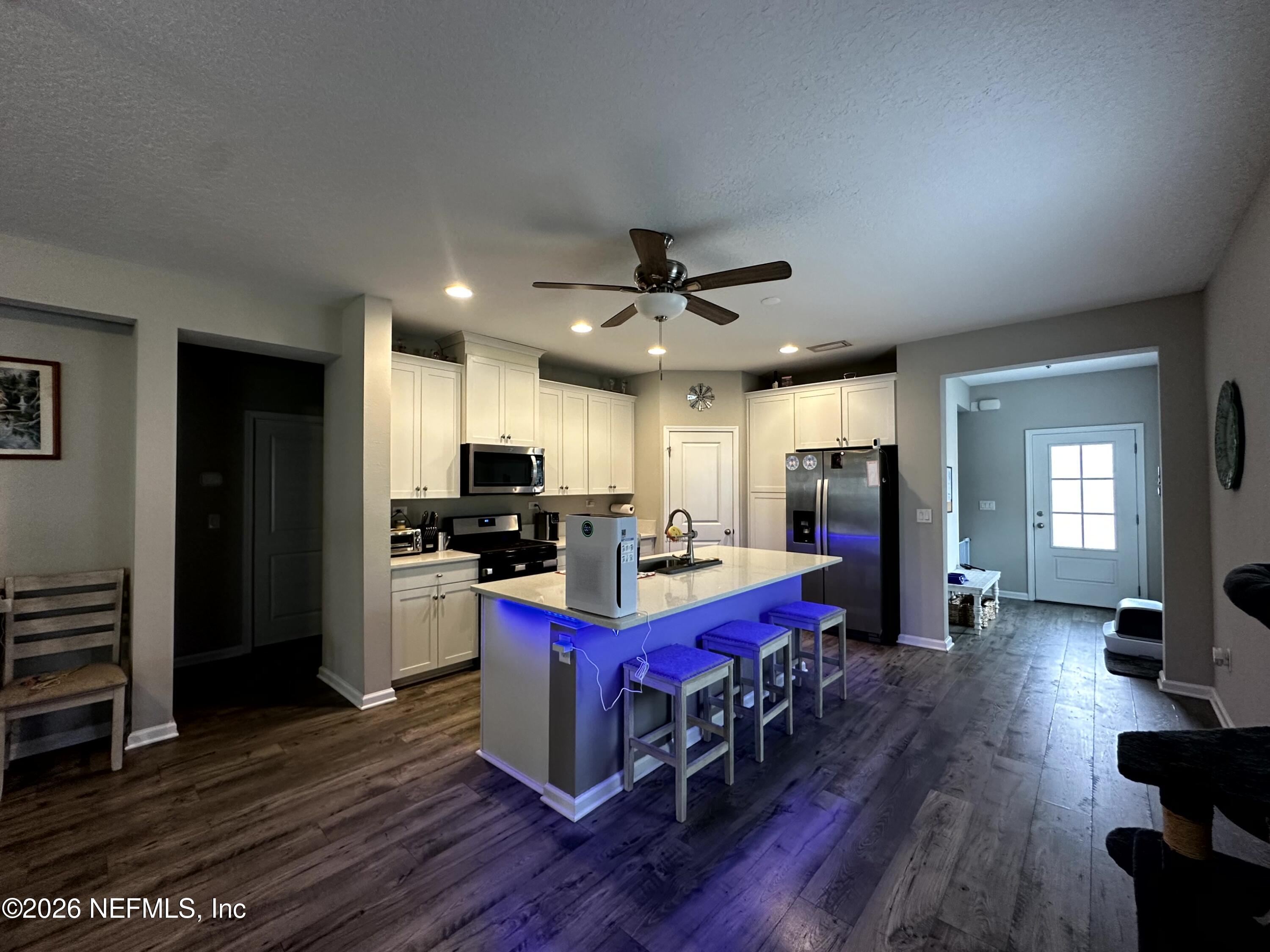 177 Clarys Run St. Augustine, FL 32092 - Photo 14 of 16 a kitchen with sink refrigerator and wooden floor