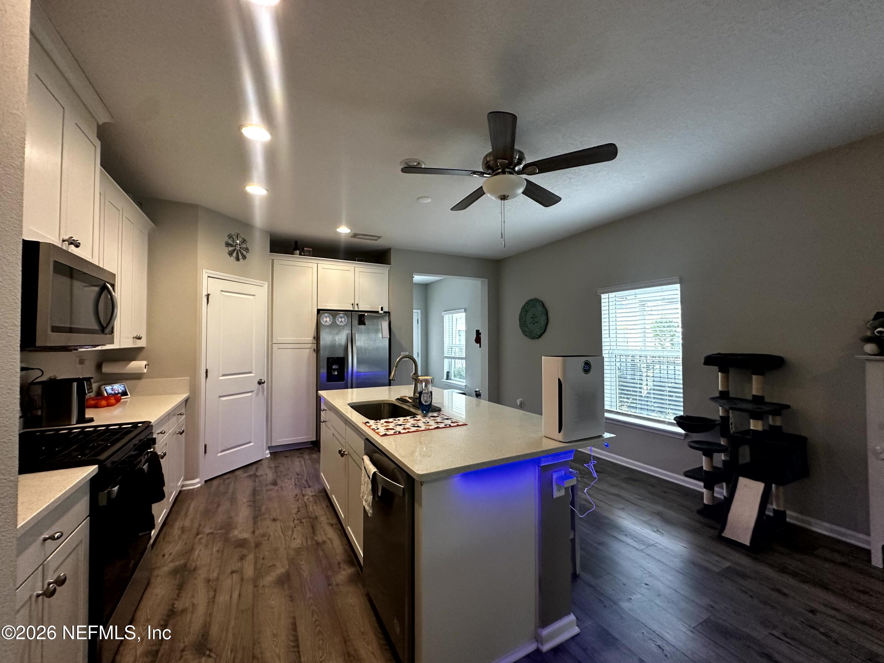 177 Clarys Run St. Augustine, FL 32092 - Photo 5 of 16 a kitchen that has a lot of cabinets a sink and appliances