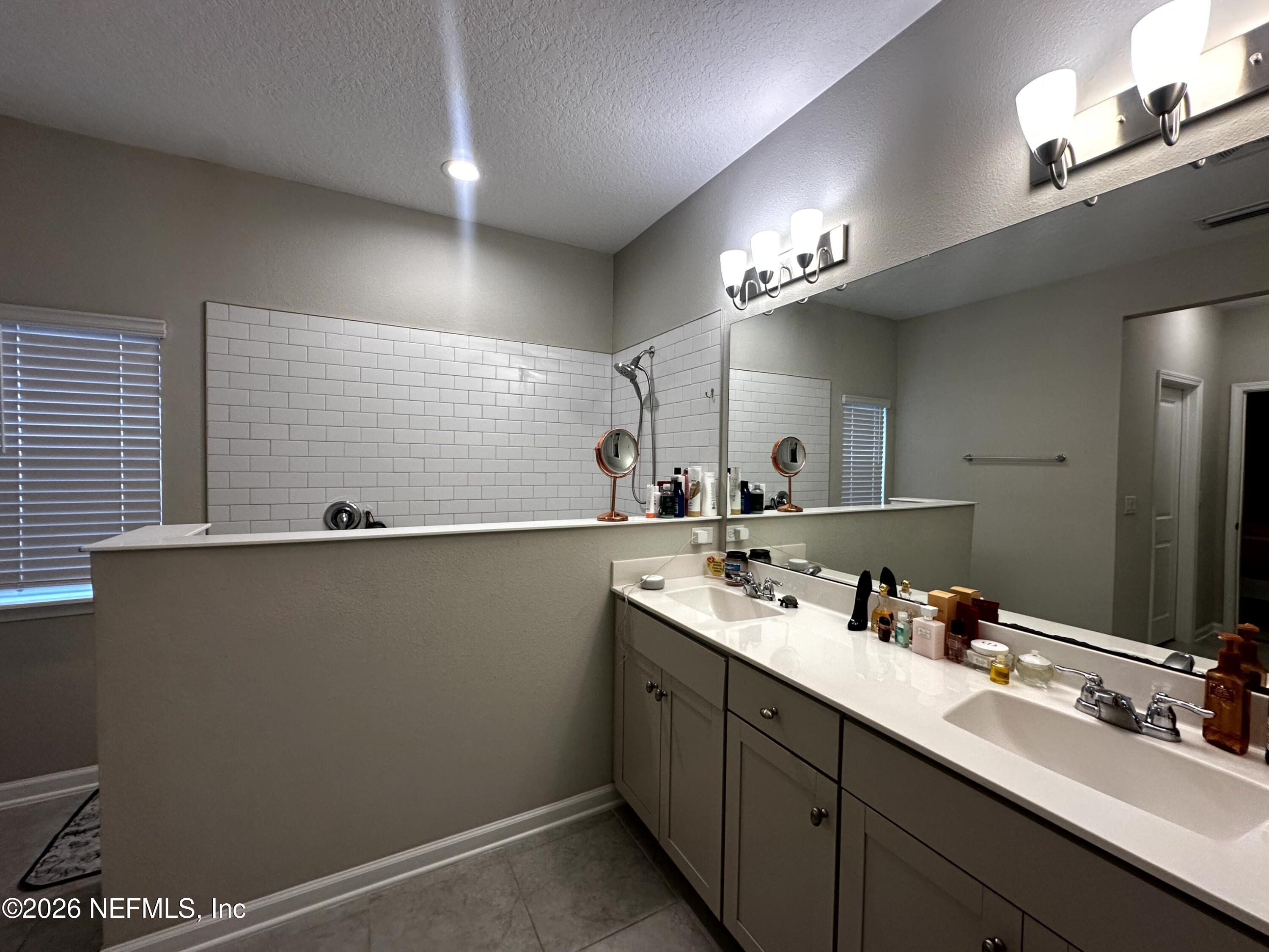 177 Clarys Run St. Augustine, FL 32092 - Photo 8 of 16 a bathroom with a double vanity sink and a mirror