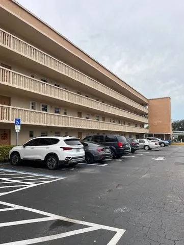 a view of a green field with trees in the background