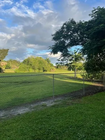 a kitchen with granite countertop a refrigerator stove and microwave