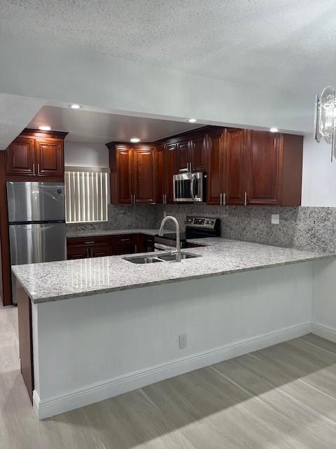 5100 Southwest 90th Avenue, Unit 410 Cooper City, FL 33328 - Photo 6 of 15 a kitchen with stainless steel appliances granite countertop a sink a stove and a microwave oven