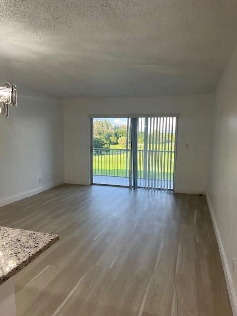 5100 Southwest 90th Avenue, Unit 410 Cooper City, FL 33328 - Photo 7 of 15 a view of an empty room with wooden floor and a window