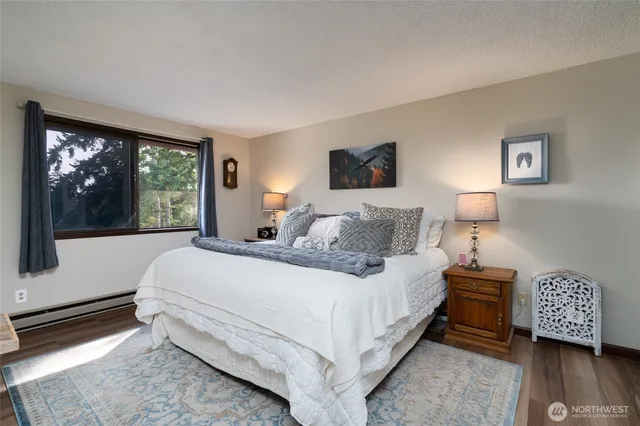 a bedroom with a bed and a large window