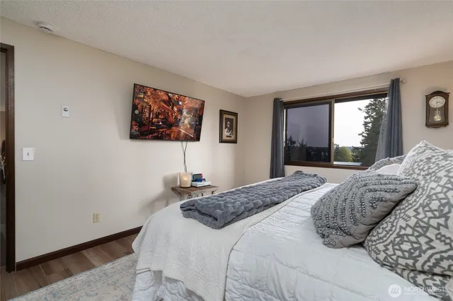 a bedroom with a bed and a large window