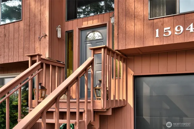 a view of an entryway with wooden floor