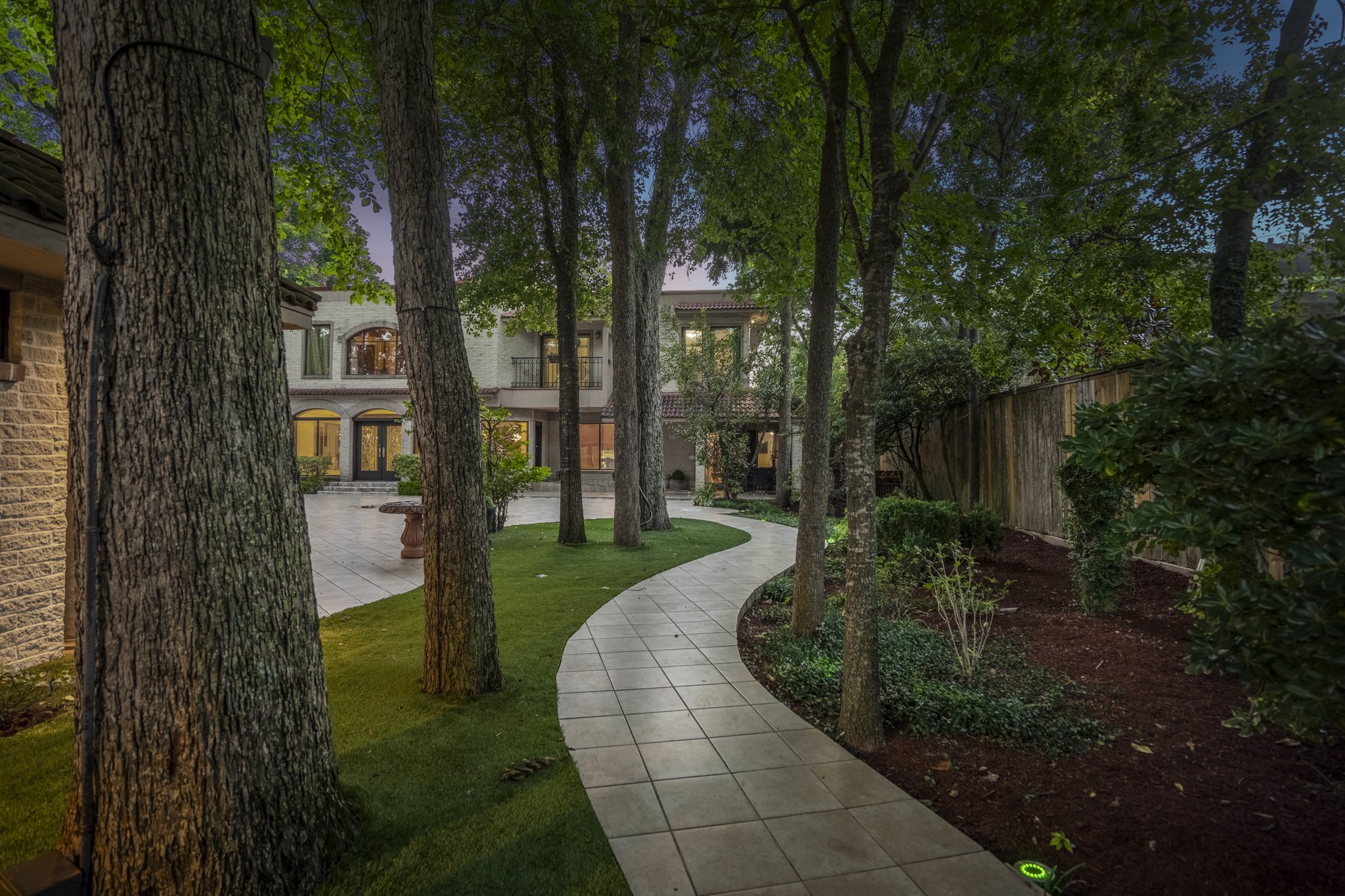 6535 Buffalo Speedway Houston, TX 77005 - Photo 7 of 40 Wander through a serene side path lined with mature trees and bordered by elegant tiled walkways that will take you on a journey through the lush landscaping.