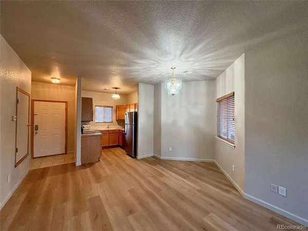 a view of a hallway with a kitchen