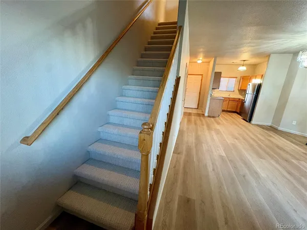 a view of entryway and hall with wooden floor