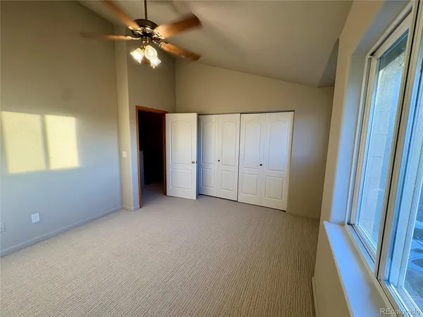 an empty room with fan and entrance