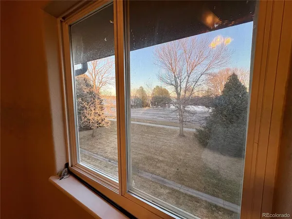 a view of a room that has a glass door and a window