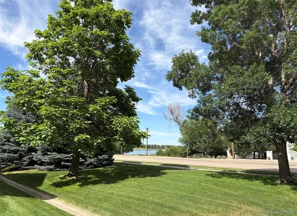 a view of a pond with green space