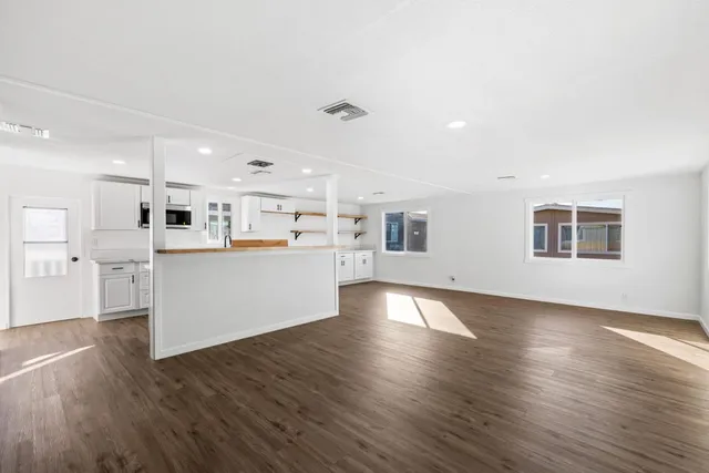 a view of a house with gym equipment and a large tree