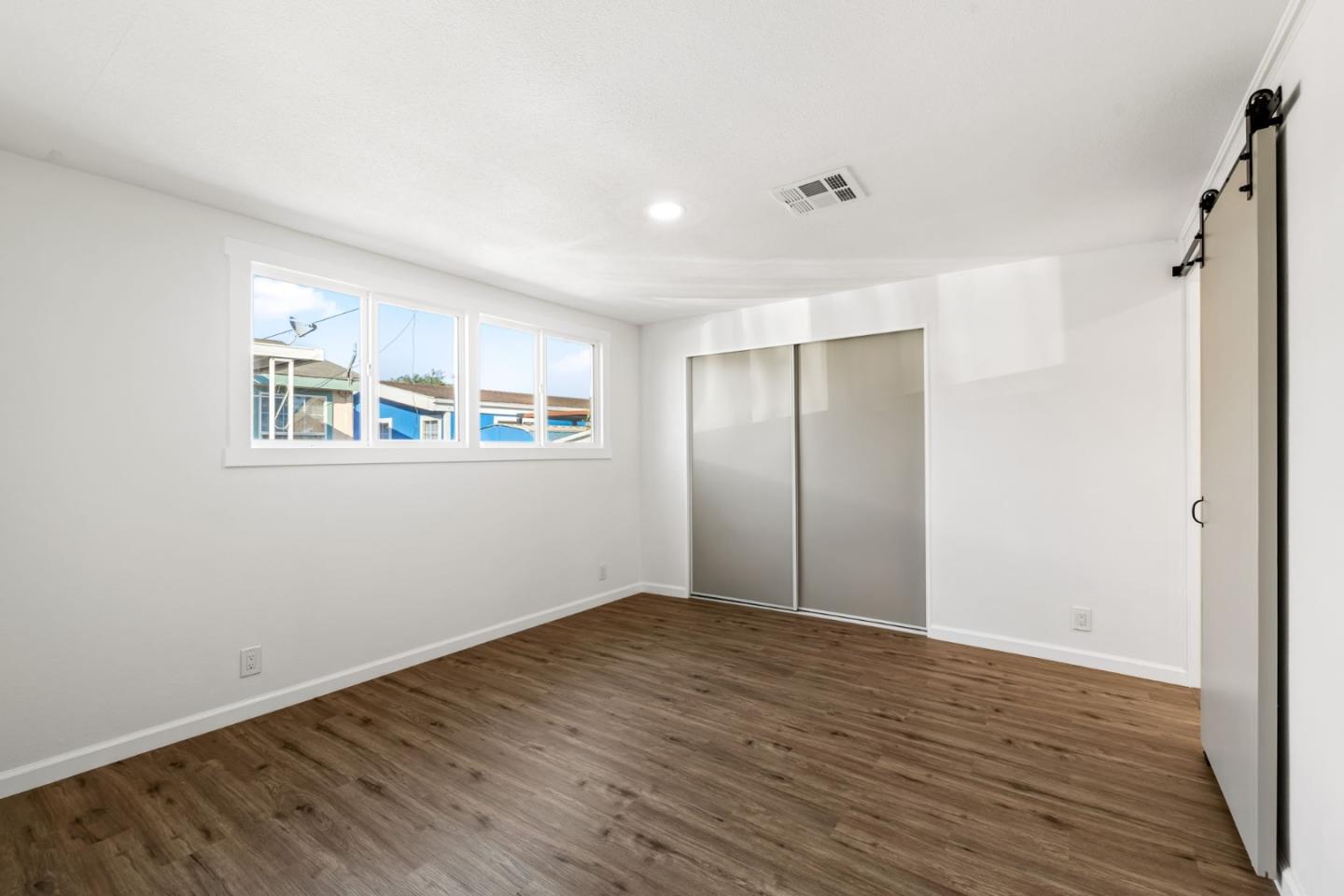 20 Russell Road, Unit 86 Salinas, CA 93906 - Photo 35 of 43 a view of an empty room with wooden floor and a window