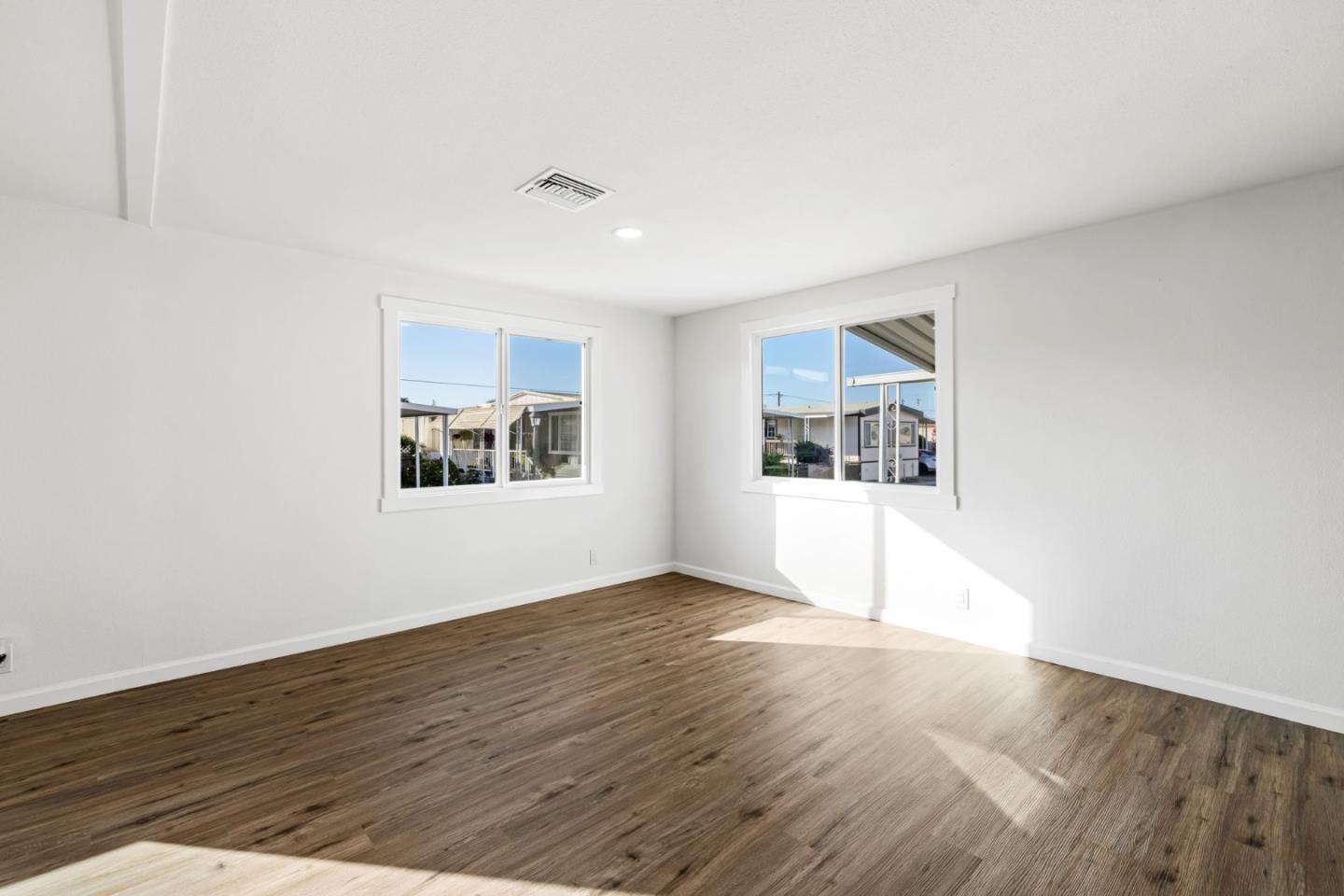 20 Russell Road, Unit 86 Salinas, CA 93906 - Photo 6 of 43 an empty room with wooden floor and windows