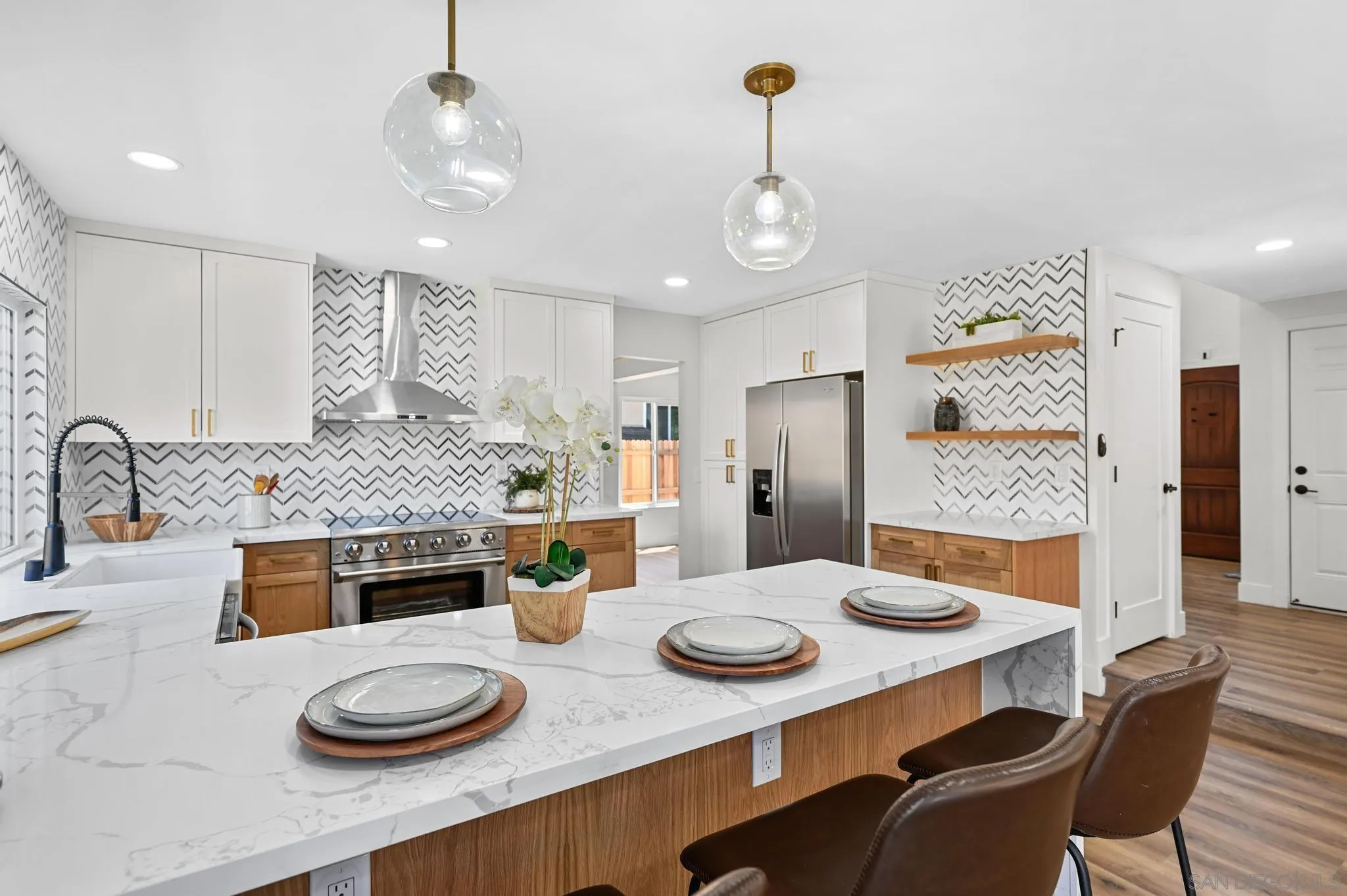 14463 Janal Way San Diego, CA 92129 - Photo 15 of 44 a kitchen with stainless steel appliances granite countertop a table and chairs in it
