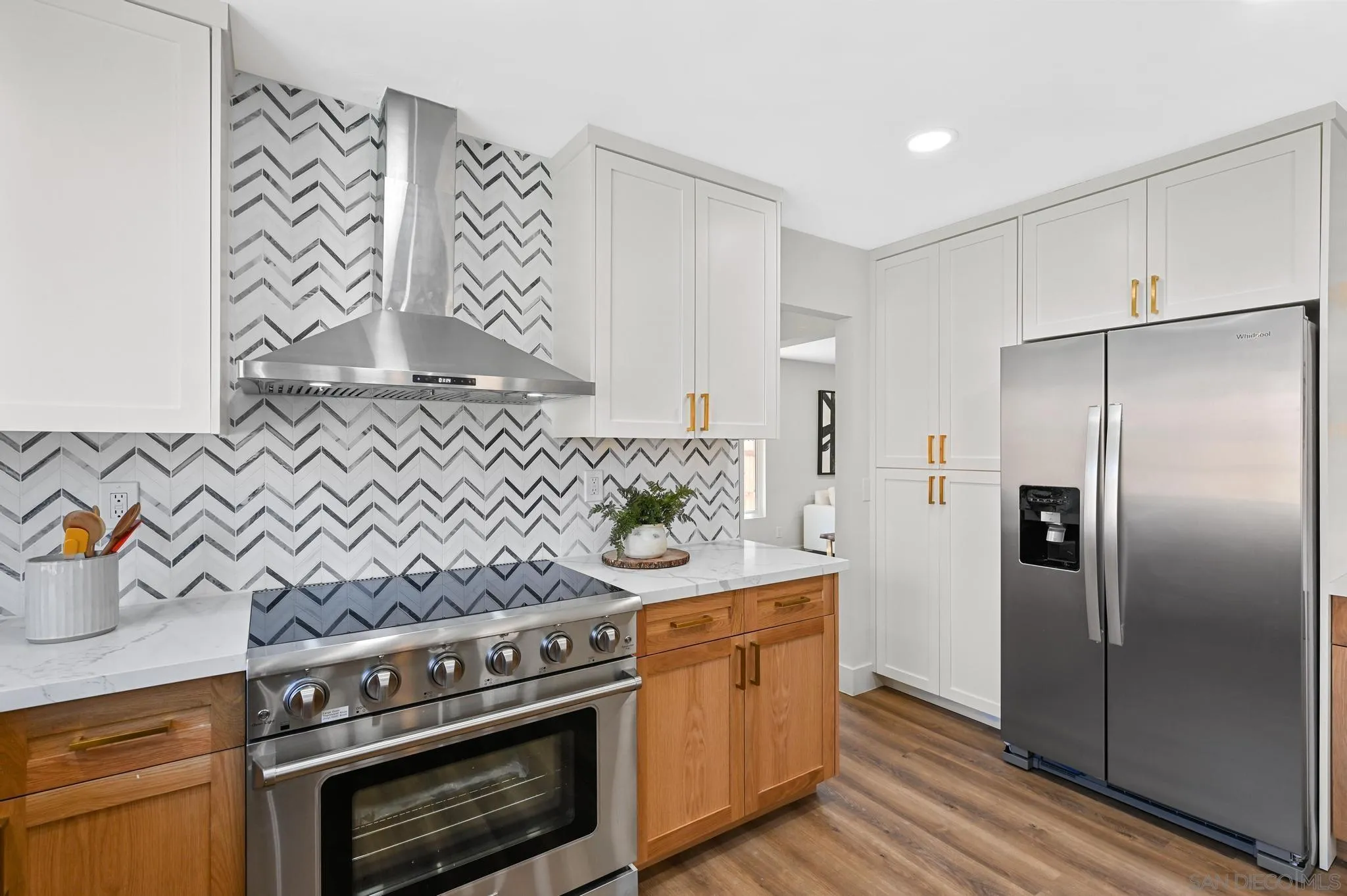 14463 Janal Way San Diego, CA 92129 - Photo 18 of 44 a kitchen with stainless steel appliances wooden floor sink stove and refrigerator