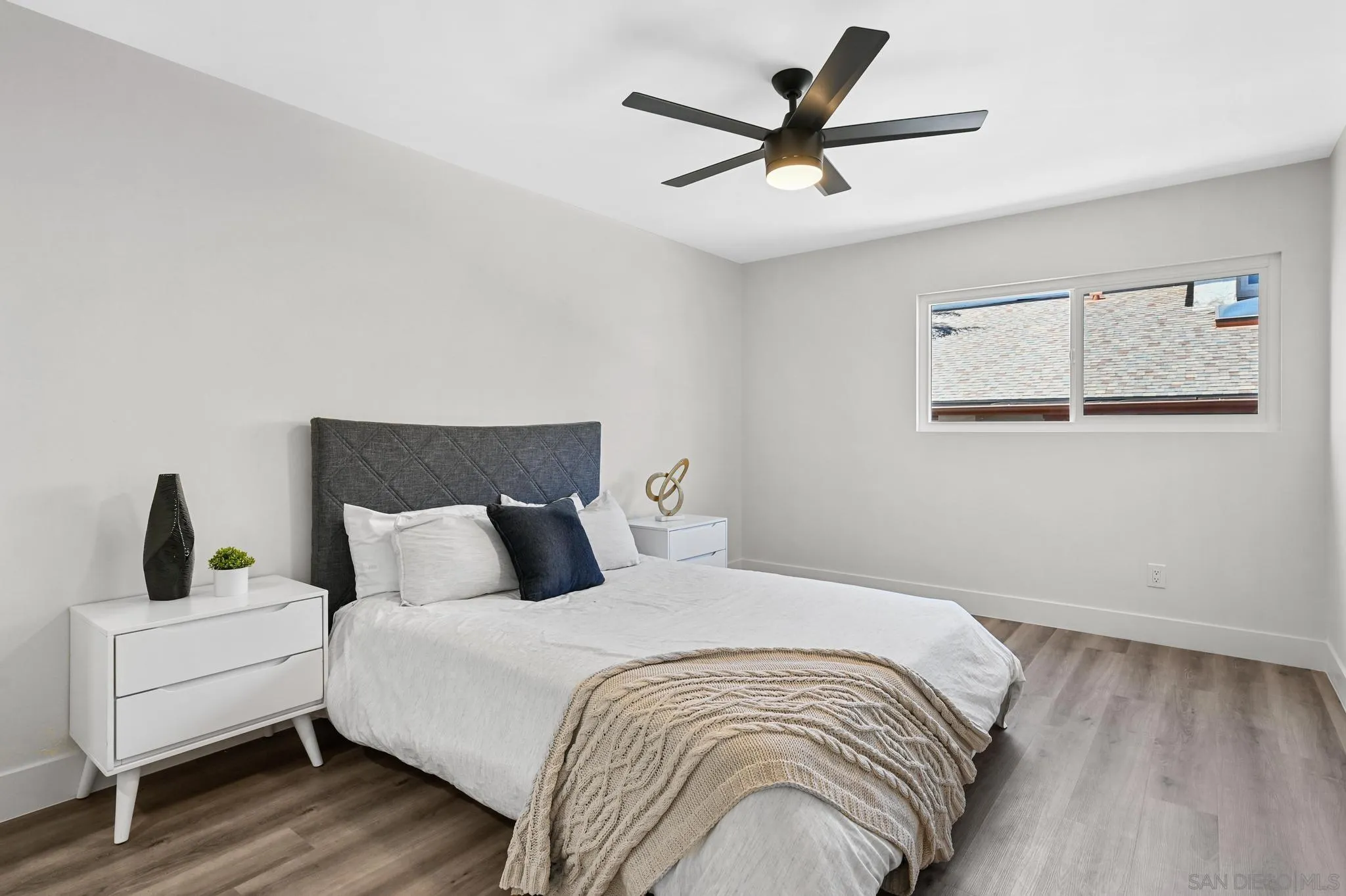 14463 Janal Way San Diego, CA 92129 - Photo 24 of 44 a bedroom with a large bed and a ceiling fan