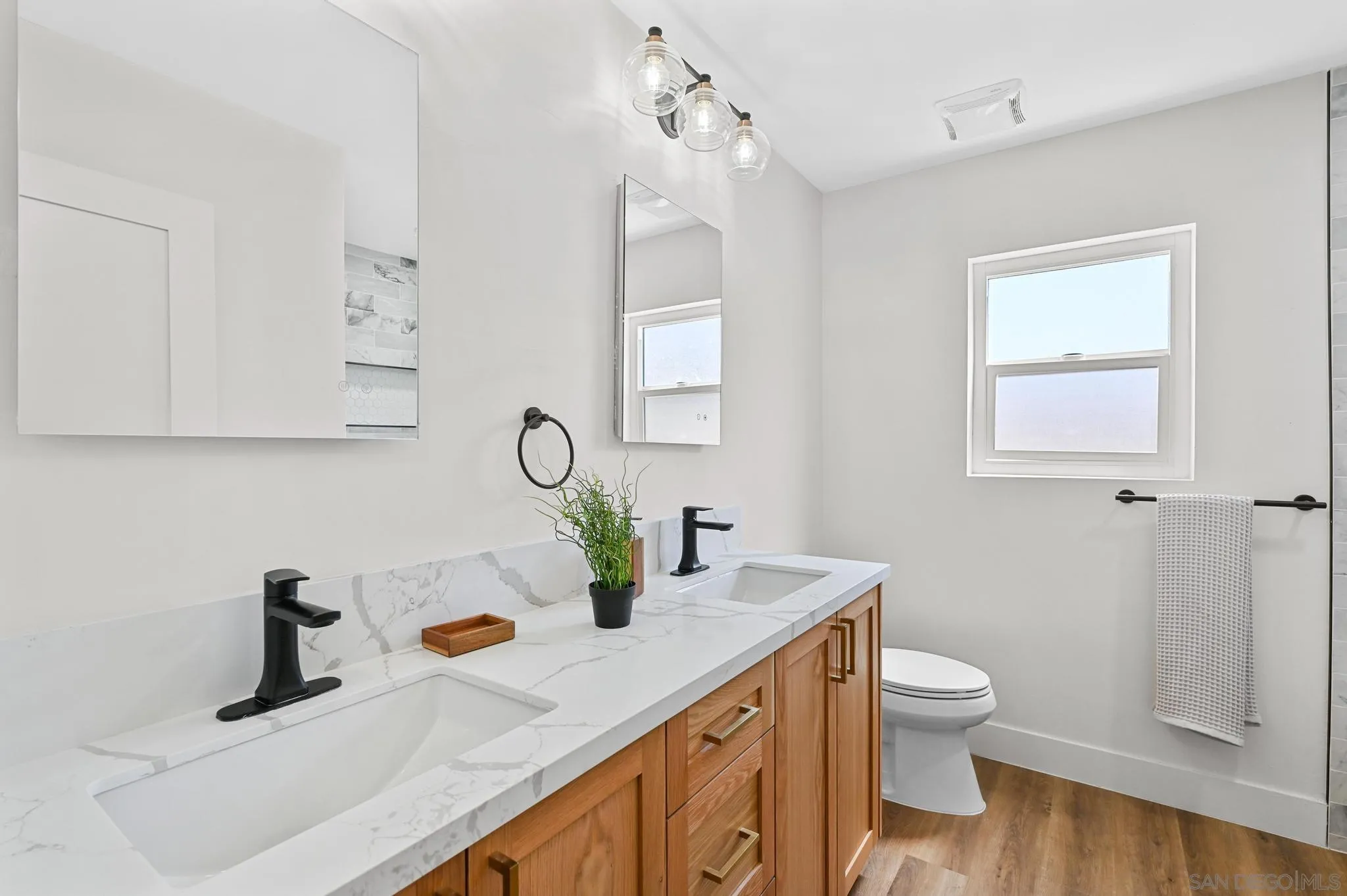 14463 Janal Way San Diego, CA 92129 - Photo 28 of 44 a bathroom with a sink a toilet and mirror
