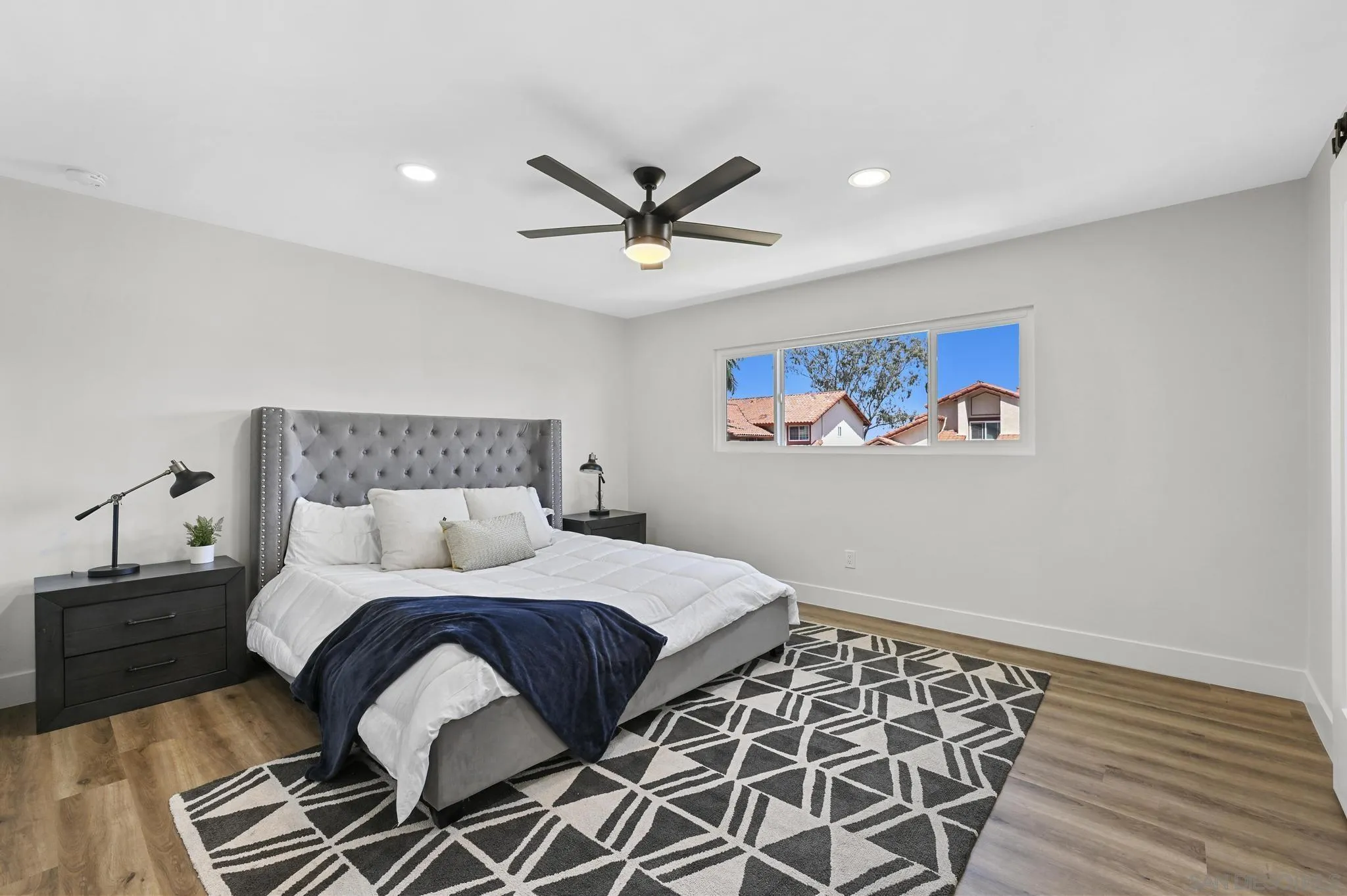 14463 Janal Way San Diego, CA 92129 - Photo 29 of 44 a bedroom with a bed and wooden floor