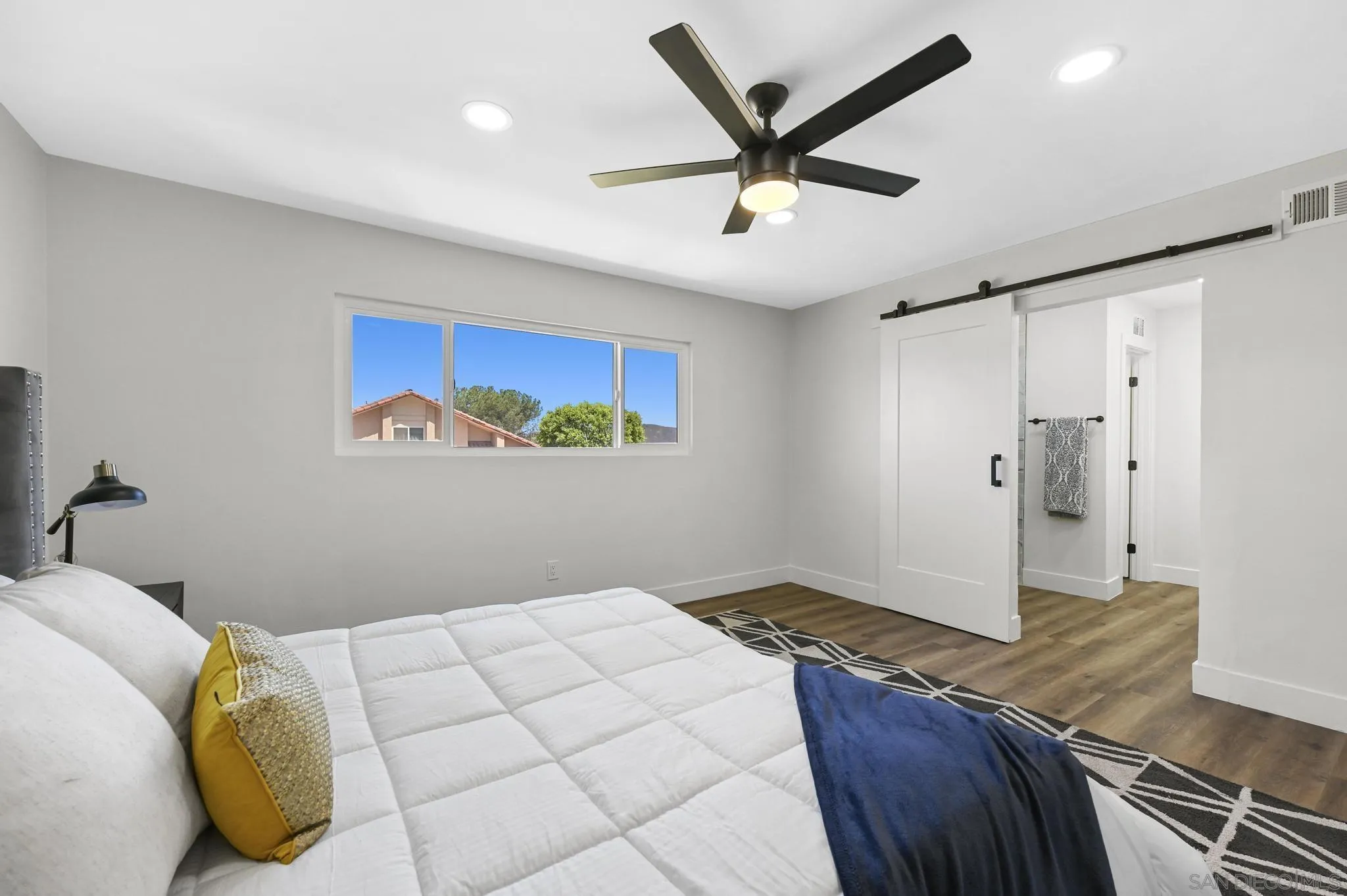 14463 Janal Way San Diego, CA 92129 - Photo 30 of 44 a bedroom with a bed and a painting on the wall