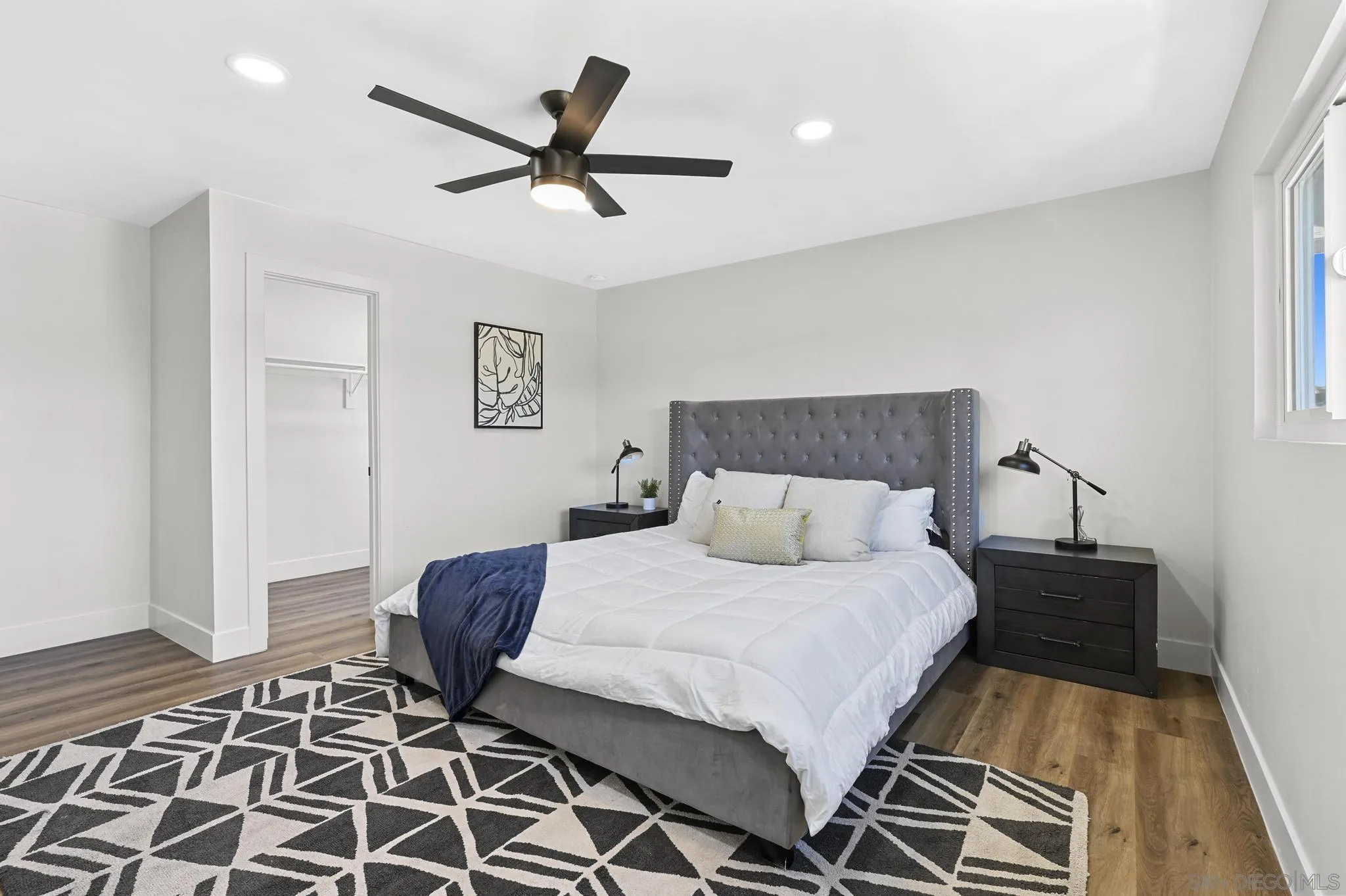 14463 Janal Way San Diego, CA 92129 - Photo 31 of 44 a bedroom with a bed and wooden floor