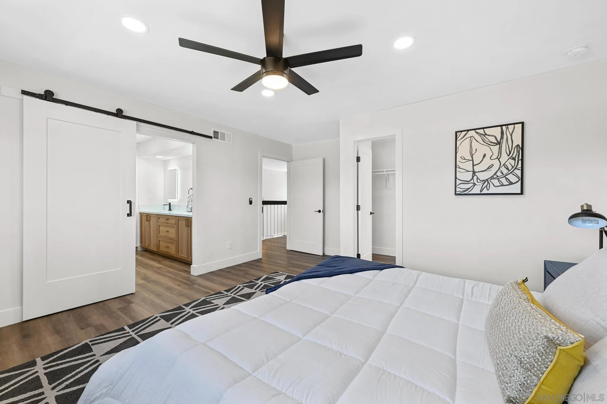 14463 Janal Way San Diego, CA 92129 - Photo 32 of 44 a bedroom with a bed and a chandelier