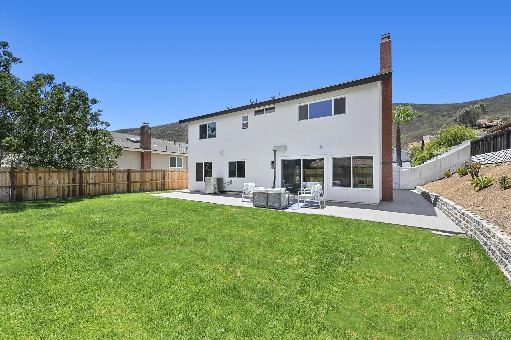 14463 Janal Way San Diego, CA 92129 - Photo 37 of 44 a view of a house with backyard sitting area and garden