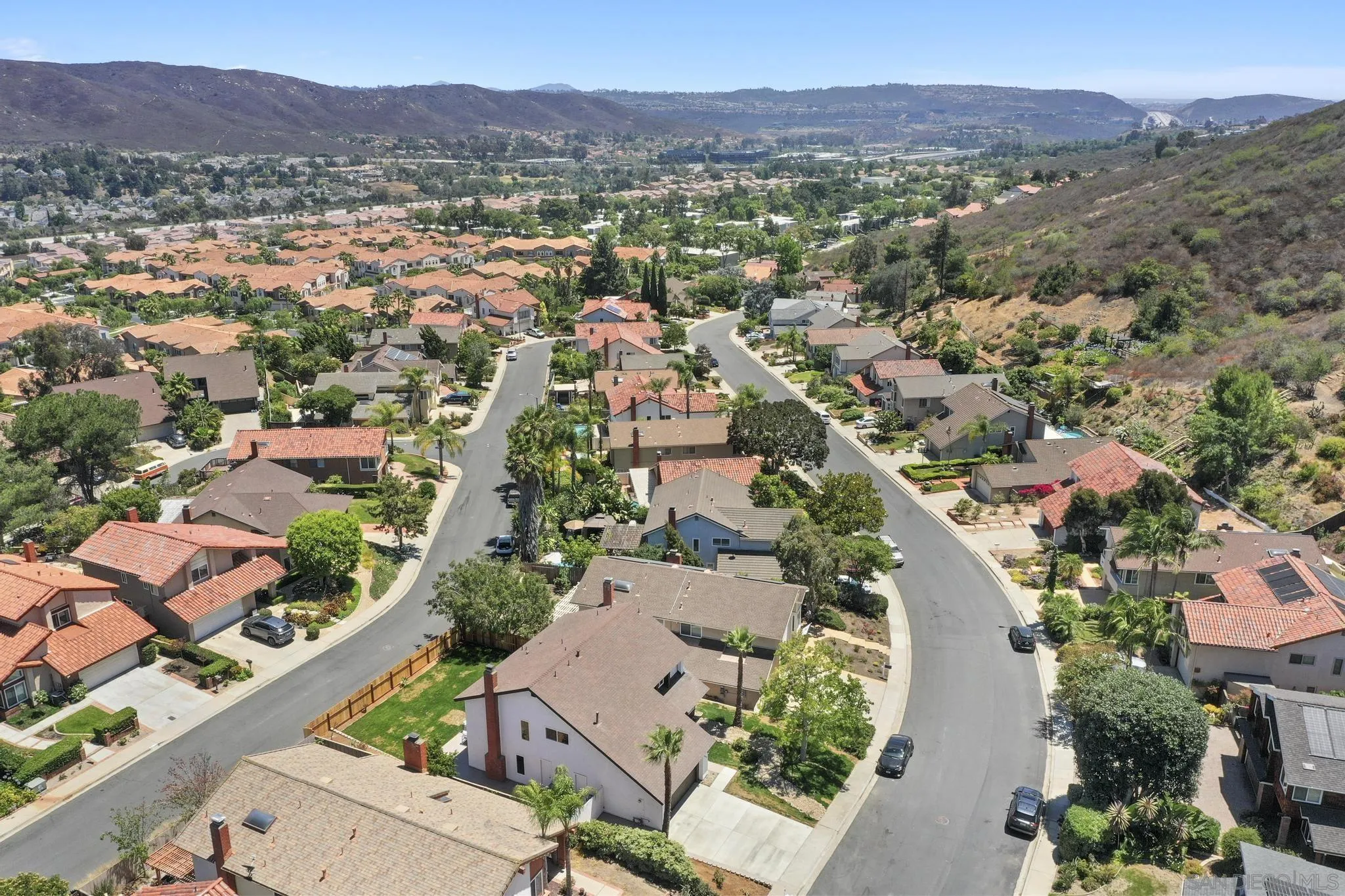 14463 Janal Way San Diego, CA 92129 - Photo 40 of 44 an aerial view of a city with lots of residential buildings and mountain view in back