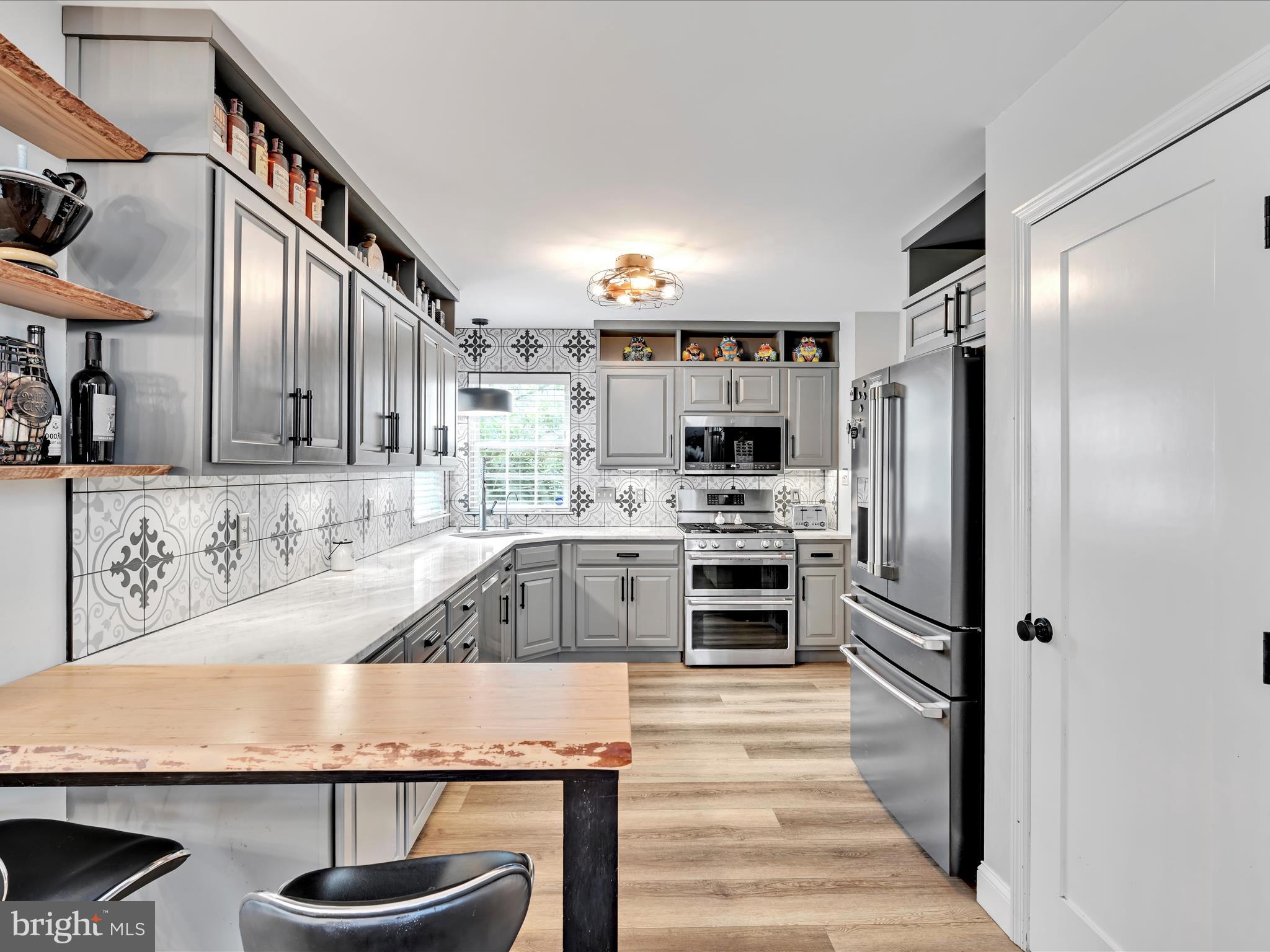 2518 Jacob Drive Reading, PA 19608 - Photo 13 of 41 a kitchen with kitchen island granite countertop a refrigerator oven a sink and dishwasher