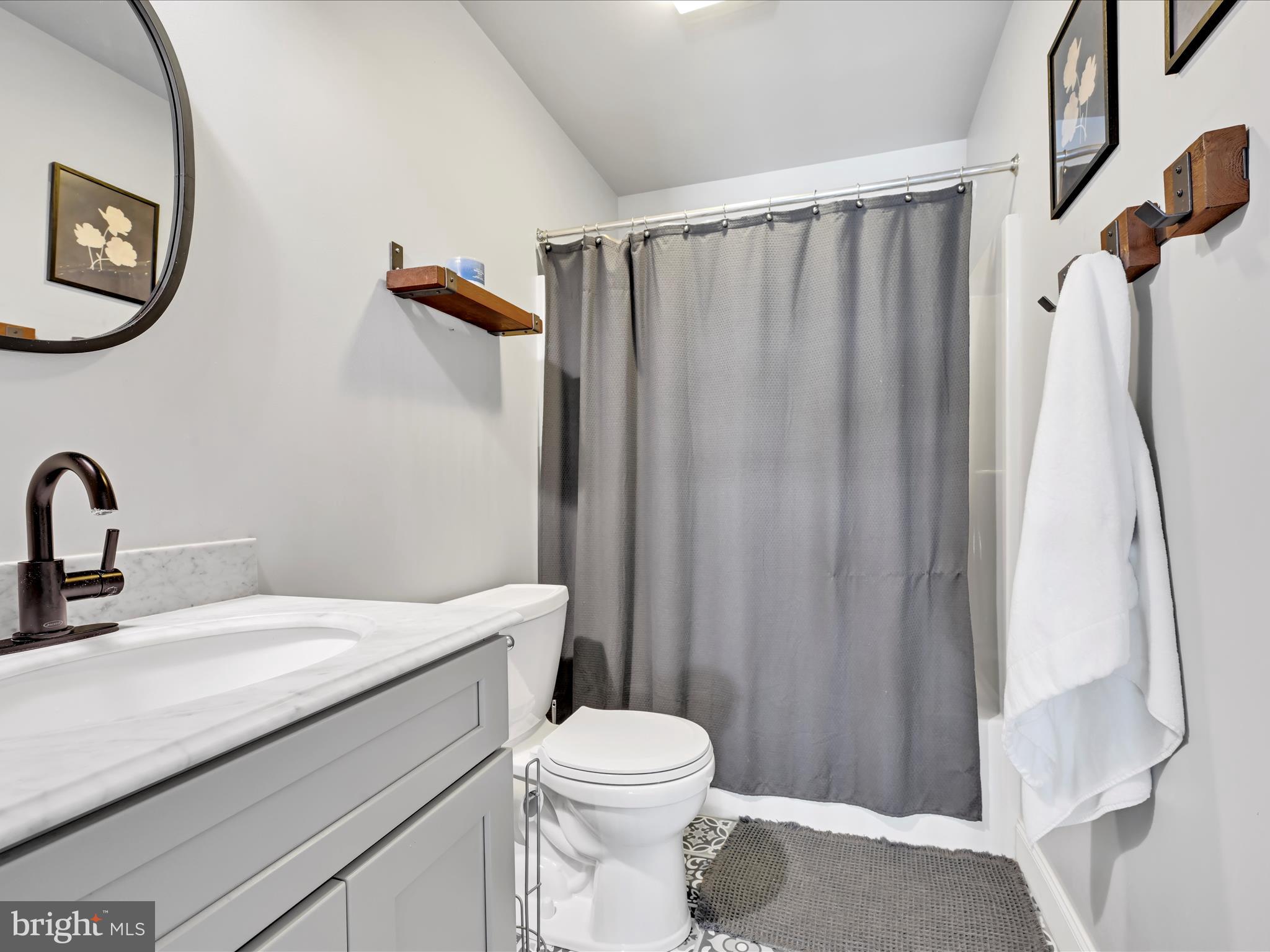 2518 Jacob Drive Reading, PA 19608 - Photo 31 of 41 a bathroom with a sink a toilet and shower curtain
