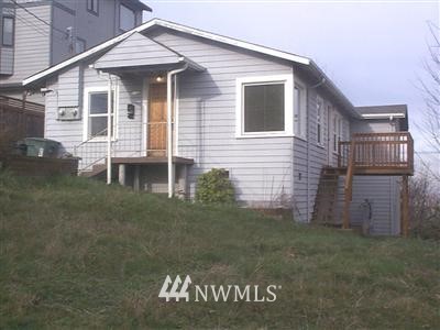 602 Southwest Othello Street Seattle, WA 98106 - Photo 1 of 1 a front view of a house with a yard