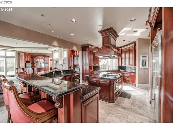 a kitchen with stainless steel appliances granite countertop a stove and a sink