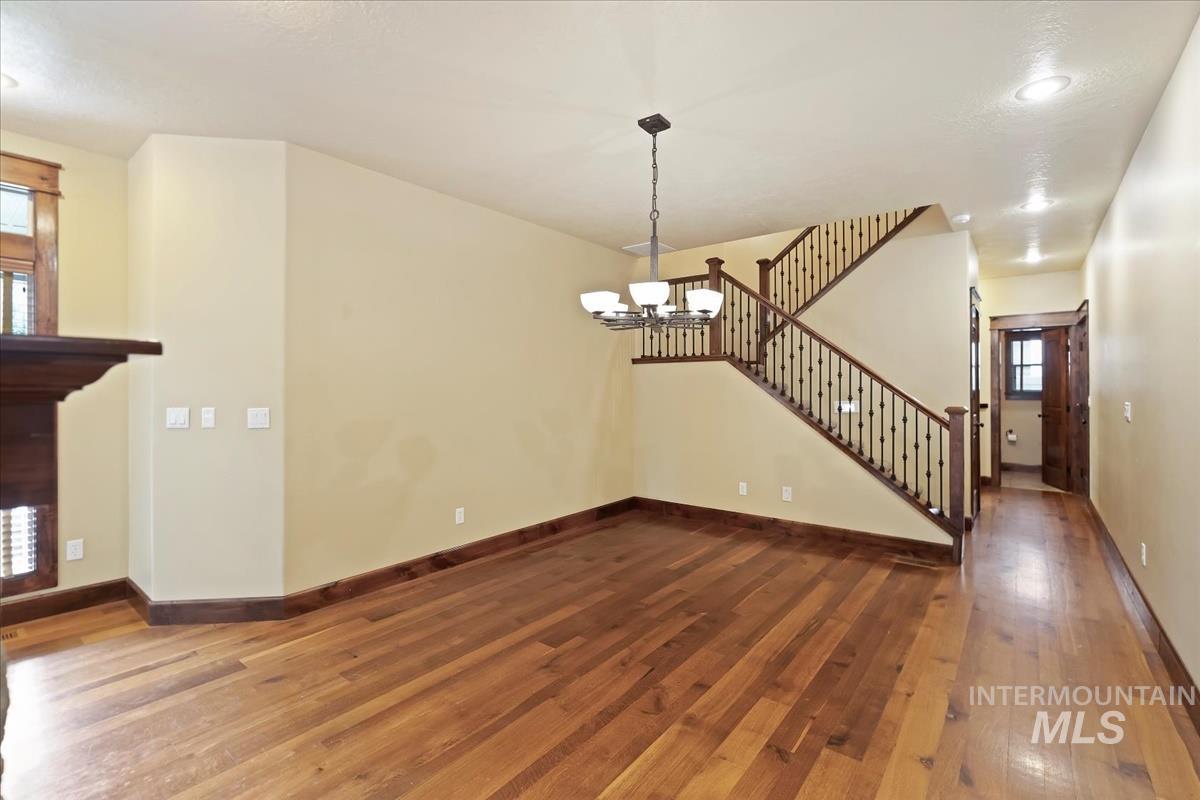 2543 West Divide Creek Street Meridian, ID 83646 - Photo 19 of 49 Unfurnished living room with stairway, hardwood / wood-style floors, recessed lighting, and a chandelier