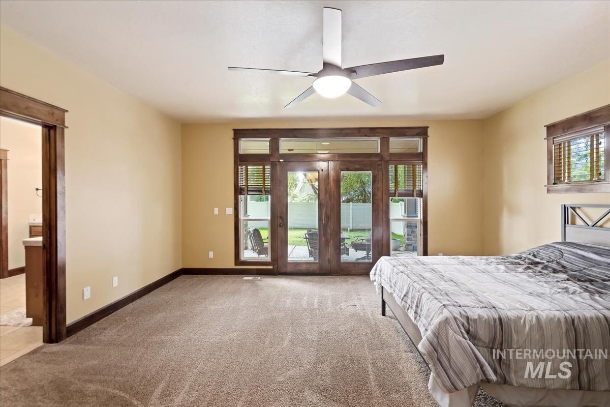 2543 West Divide Creek Street Meridian, ID 83646 - Photo 20 of 49 Carpeted bedroom featuring access to exterior, multiple windows, and ceiling fan