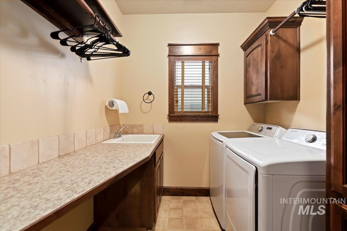 2543 West Divide Creek Street Meridian, ID 83646 - Photo 28 of 49 Laundry area with washing machine and dryer and cabinet space