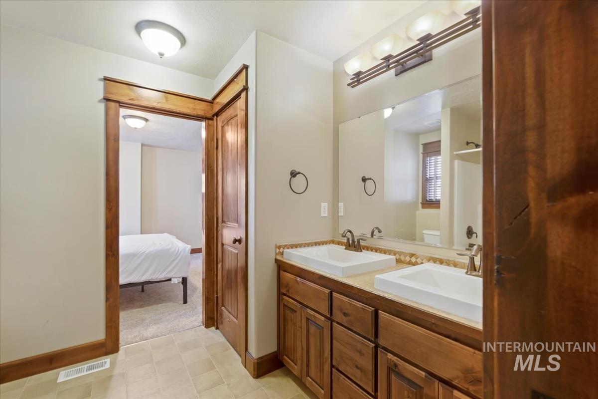2543 West Divide Creek Street Meridian, ID 83646 - Photo 34 of 49 Ensuite bathroom with double vanity and light colored carpet