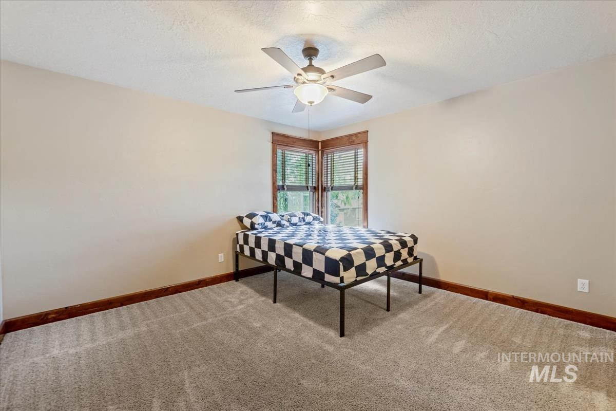 2543 West Divide Creek Street Meridian, ID 83646 - Photo 35 of 49 Bedroom with carpet flooring, a textured ceiling, and a ceiling fan