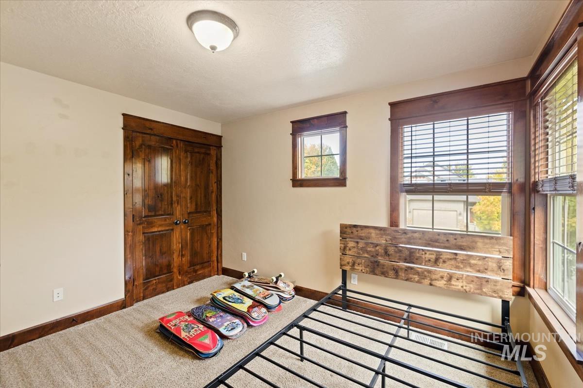2543 West Divide Creek Street Meridian, ID 83646 - Photo 37 of 49 Carpeted bedroom with a closet and a textured ceiling