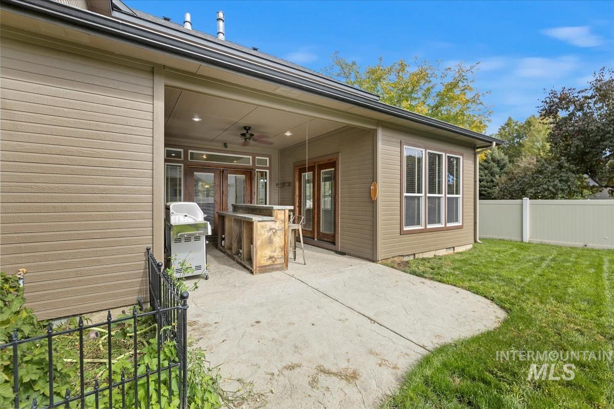 2543 West Divide Creek Street Meridian, ID 83646 - Photo 42 of 49 Fenced backyard featuring ceiling fan, a patio, and a grill