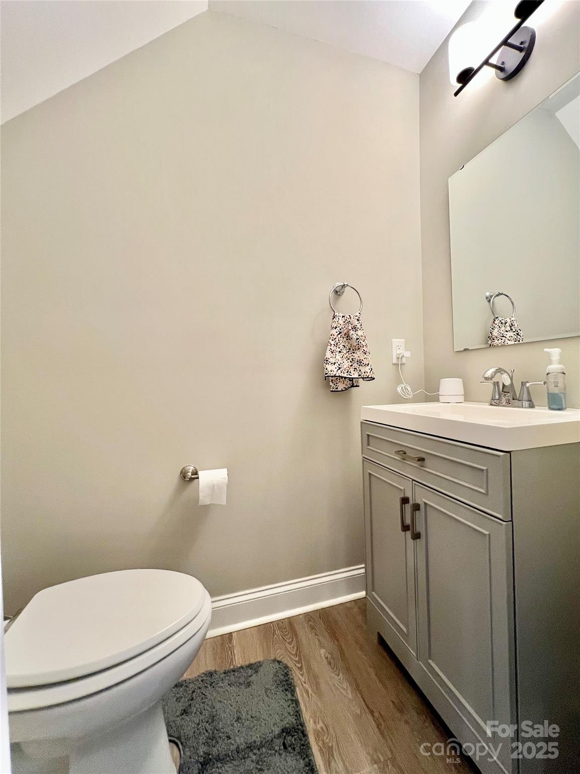 1781 17th Avenue Northeast Hickory, NC 28601 - Photo 14 of 26 a bathroom with a sink vanity mirror and toilet