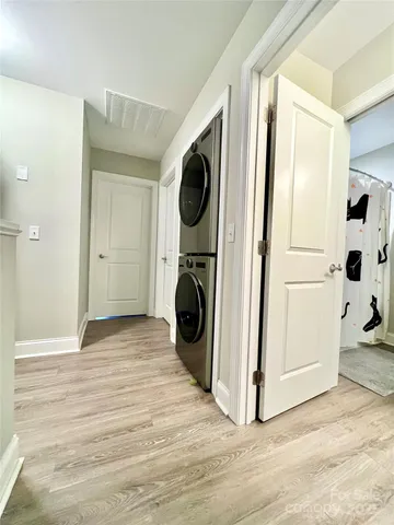 a view of a hallway with washer and dryer