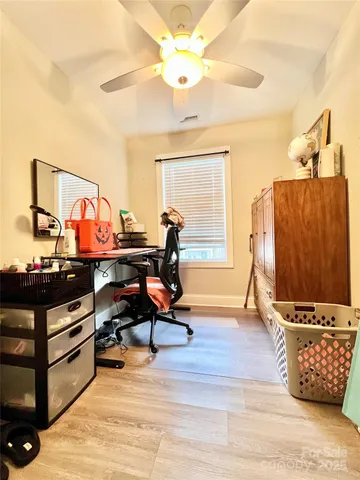 a living room with furniture a piano and wooden floor