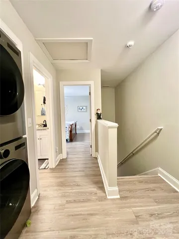a view of a living room with furniture and a wooden floor