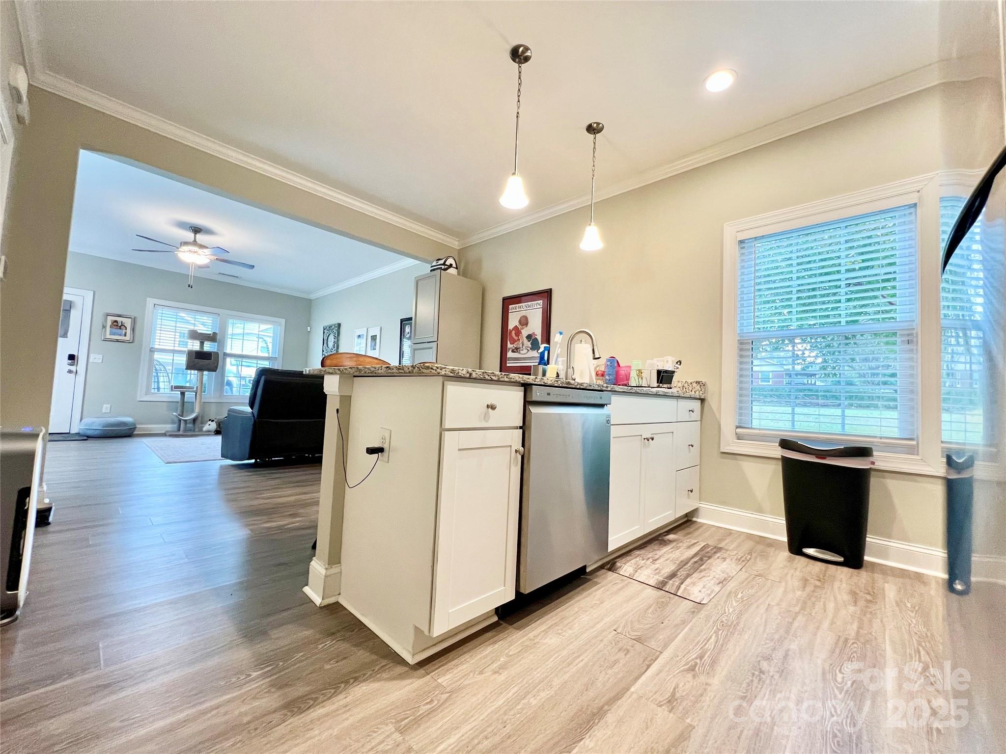 1781 17th Avenue Northeast Hickory, NC 28601 - Photo 6 of 26 a view of kitchen with granite countertop a stove top oven a sink dishwasher and a dining table with wooden floor