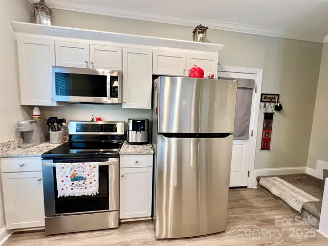 a refrigerator freezer sitting inside of a kitchen