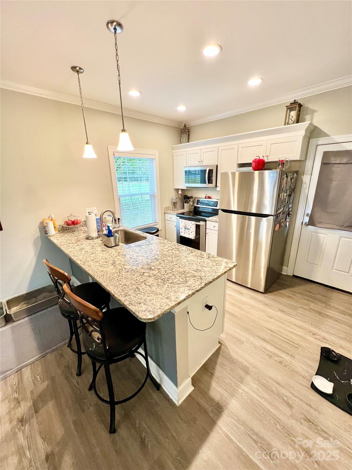 1781 17th Avenue Northeast Hickory, NC 28601 - Photo 8 of 26 a kitchen with kitchen island white cabinets and stainless steel appliances