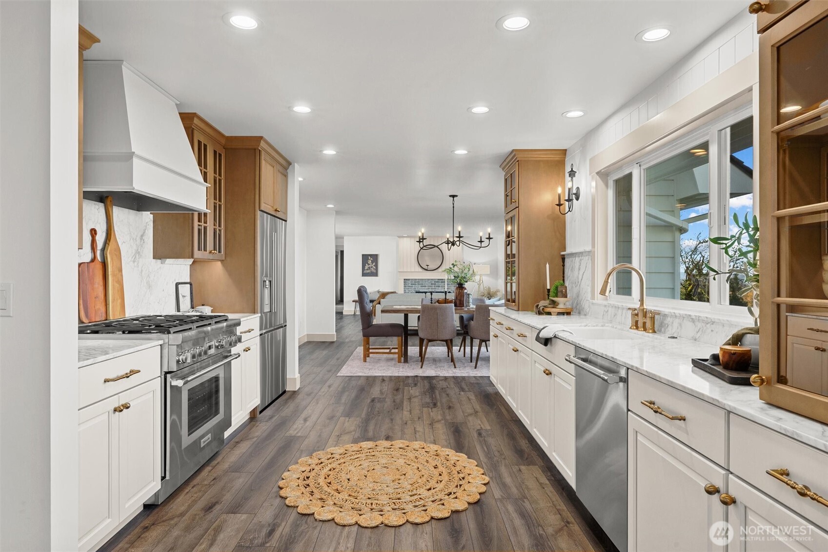 9813 Moran Road Arlington, WA 98223 - Photo 18 of 40 a large kitchen with stainless steel appliances a stove a sink dishwasher and a oven with white cabinets