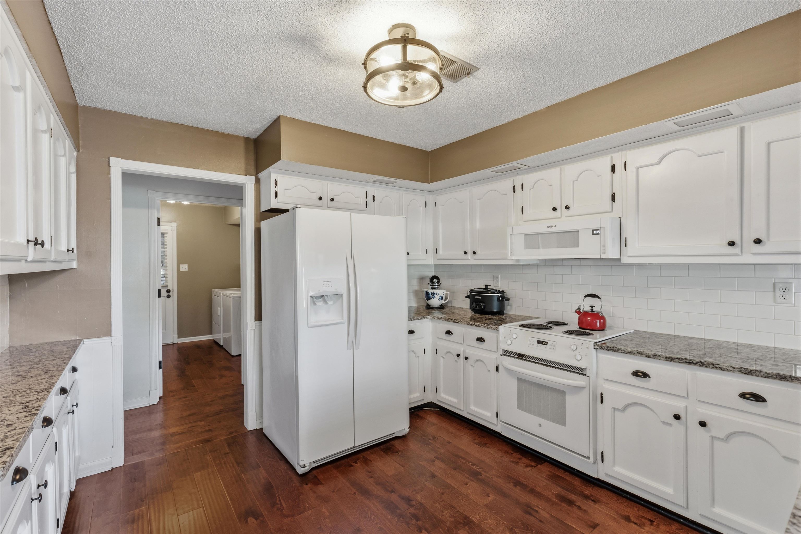 115 West Powell Road Collierville, TN 38017 - Photo 4 of 17 a kitchen with white cabinets and stainless steel appliances