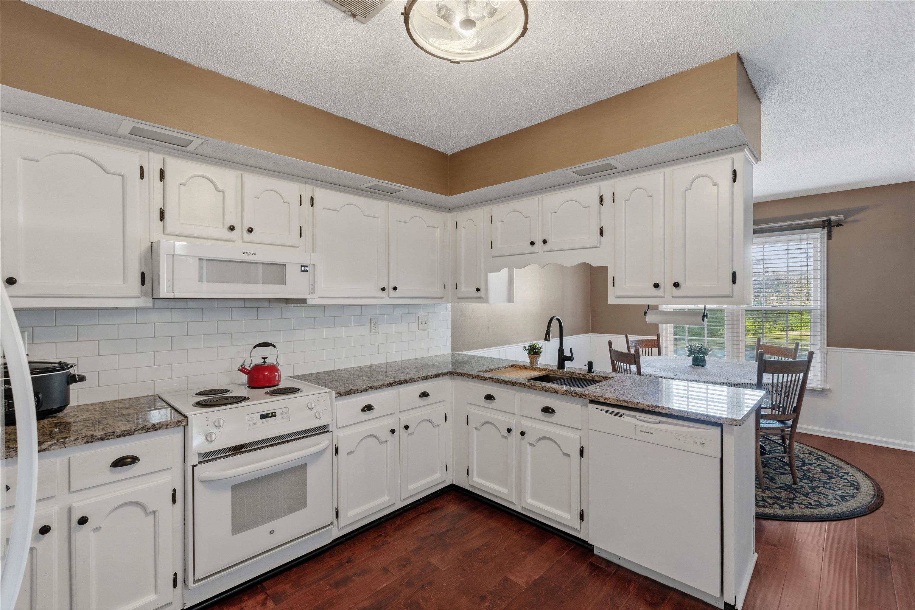 115 West Powell Road Collierville, TN 38017 - Photo 5 of 17 a kitchen with white cabinets sink and white appliances